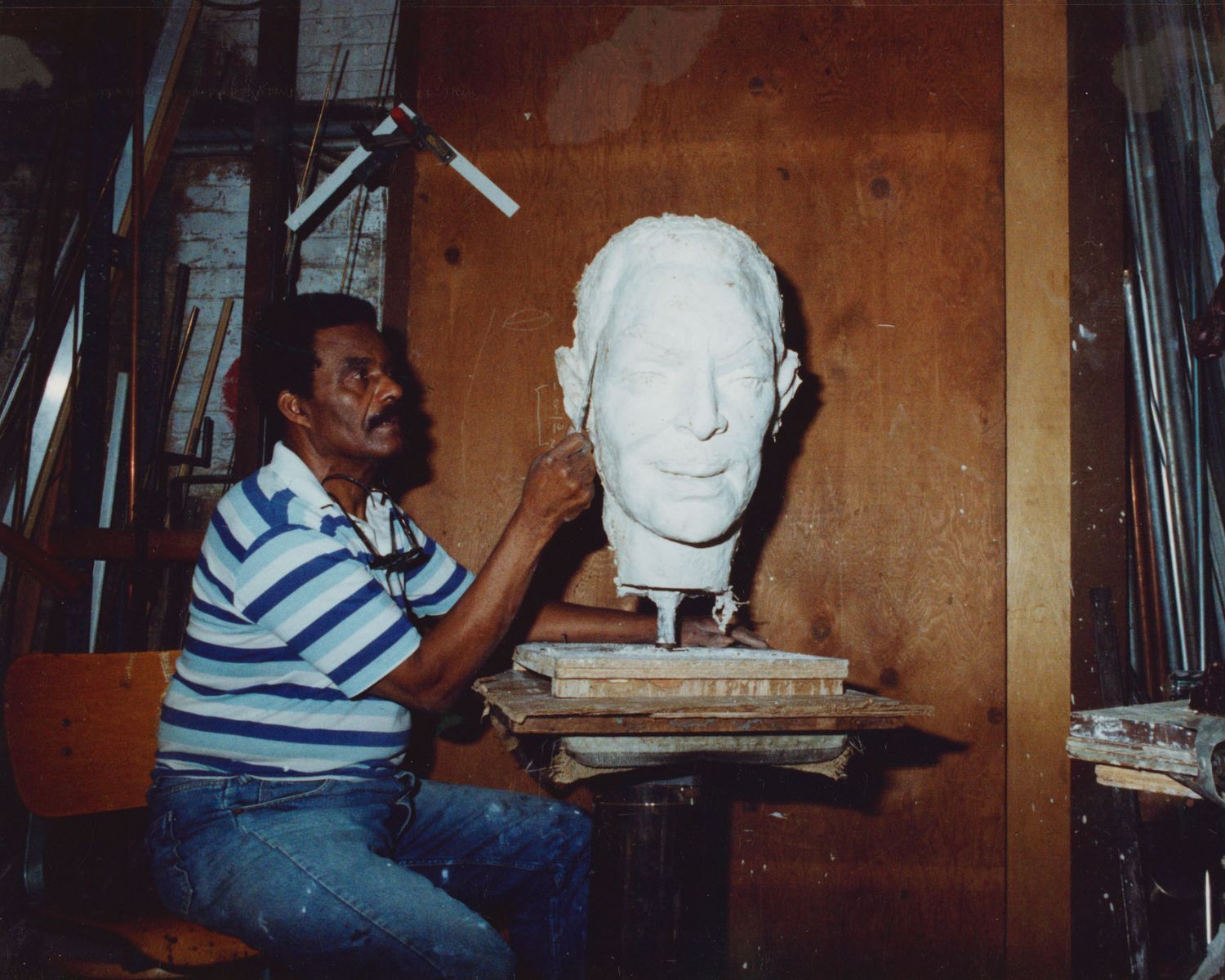 John posing with sculpture